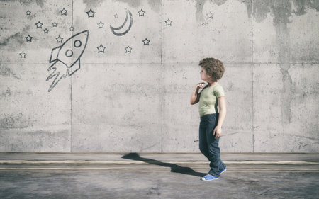 Curious kid looks to a rocket in space painted on wall. This is a 3d render illustrationの写真素材