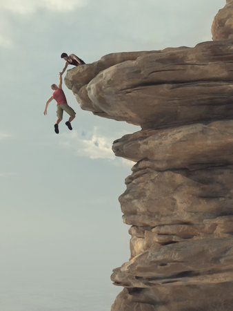Young man helping a climber to get to the top of a cliff. This is a 3d render illustration.の写真素材