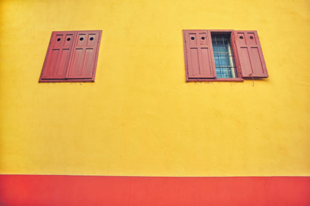 Windows with wooden shutters on a yellow wall, castle of Sighisoara, Transylvania, Romaniaの写真素材