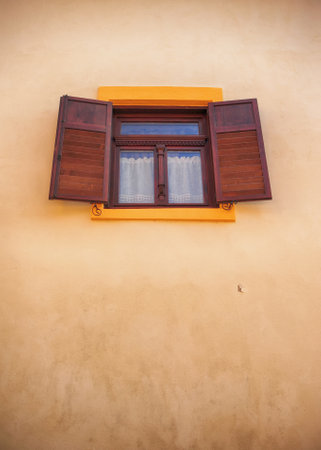Windows with wooden shutters open site; a brown wall, castle of Sighisoara, Transylvania, Romaniaの写真素材