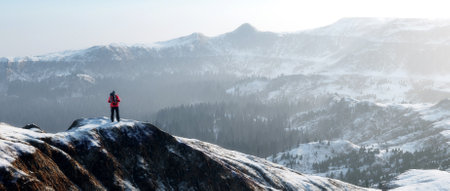 Traveler with a backpack on top of snow mountains . This is a 3d render illustration .の写真素材