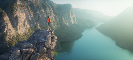 Hiker on mountain peak watching river flow through rocks. This is a 3d render illustration.の写真素材