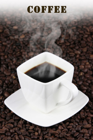 square white cup of coffee on coffee beansの写真素材