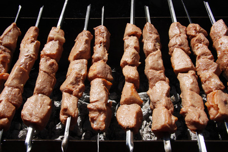 beautiful kebab on skewers over a campfireの写真素材
