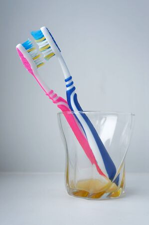 Two toothbrushes standing in a glassの写真素材