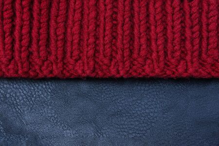 Texture: one half of a knitted scarf the other half of a piece of leatherの写真素材