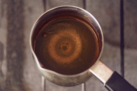 Circles on the surface of black coffee brewed in coffee pot, soft focus, tonedの写真素材