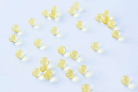 Yellow transparent balls scattered on a blue background