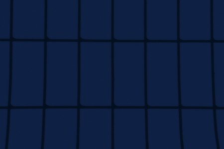 The background of the evening sky, showing through the bars of the fence