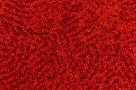 Texture from a fragment of an orange carpet with burgundy stainsの写真素材
