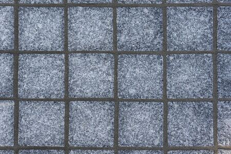 Texture of square gray paving tiles