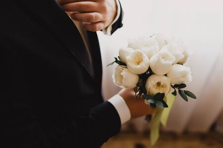 Flowers in the hands of the groom.の写真素材