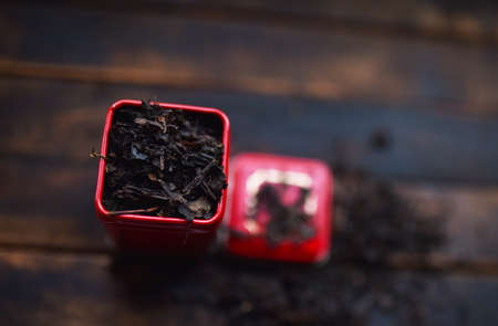 black leaf tea in a red tin canの写真素材