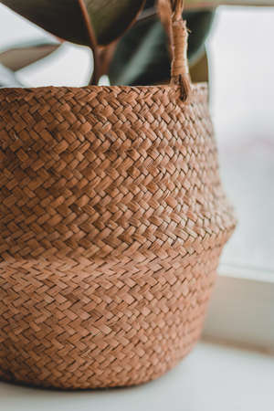 Detail of a wicker basket with a lid with natural light, sunlight and shade. Original weaving from corn fiber.の写真素材