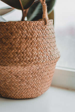 Detail of a wicker basket with a lid with natural light, sunlight and shade. Original weaving from corn fiber.の写真素材