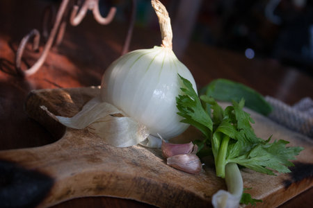 Onion and garlic on a wooden cutting board. Selective focus.の写真素材