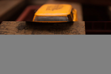 Yellow toy car on a wooden surface. Selective focus. Toned.の写真素材