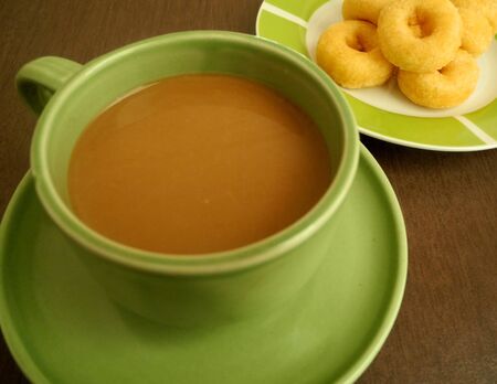 Coffee with snacks In late morning sun light timespan of the workday.の写真素材