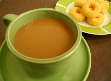 Coffee with snacks In late morning sun light timespan of the workday.の写真素材