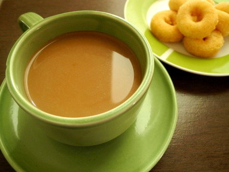 Coffee with snacks In late morning sun light timespan of the workday.の写真素材