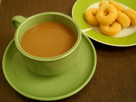 Coffee with snacks In late morning sun light timespan of the workday.の写真素材