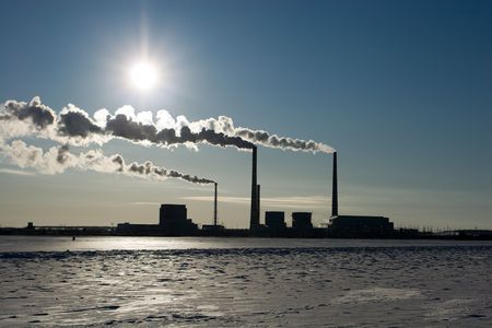 The smoke goes from pipes in a view of the sunの写真素材