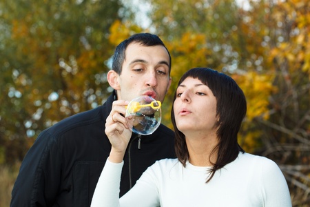 Young beautiful pair in the autumn on the nature.の写真素材