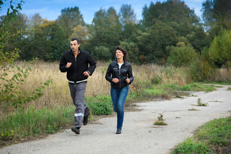 Young beautiful pair in the autumn on the nature.の写真素材