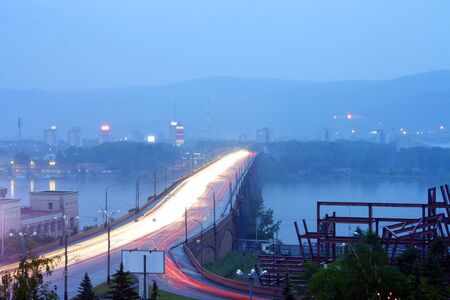 Krasnoyarsk, view of the Yenisei and Municipal Bridge at dusk, prolonged exposure.の写真素材