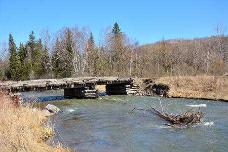 Wooden bridge over the Siberian river Kurgusuul, Republic of Khakassia, Russiaの写真素材