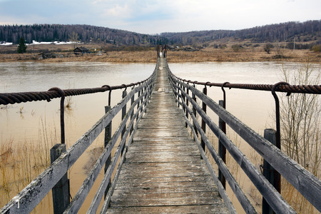Suspended pedestrian bridge over the river Berd, in the village of Peteni, Novosibirsk region