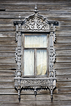 Tomsk, old wooden house window decorated with wood carvingsの写真素材