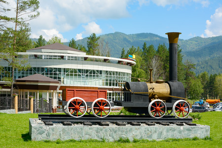 The layout of the old steam locomotive on the pedestal in the recreation center in Mountain Altai