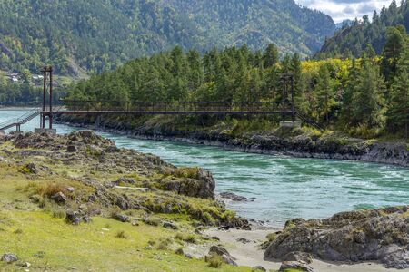 Suspended pedestrian bridge over the Katun river near the village of Elanda, Altai Republic,Russiaの写真素材
