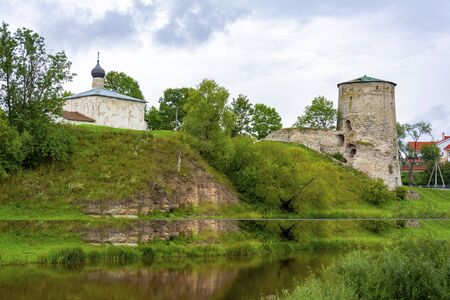 Pskov, Gremyachaya fortress tower and the ancient Church of Kozma and Damian from Gremyachaya mountain on the high Bank of the Pskova riverの写真素材