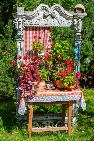 Stylized decorative window with flowers, an interesting garden decorationの写真素材