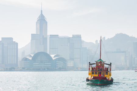 Hong Kong skyline with boats in Victoria Harbor.のeditorial素材