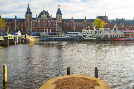 Amsterdam, Netherlands - April 13, 2016: The view of Amsterdam Central Station with the canal in Netherlands.のeditorial素材