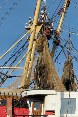 Fishing nets hanging on mastの写真素材