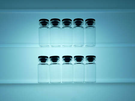 Ten vials on a light shelf in light blueの写真素材