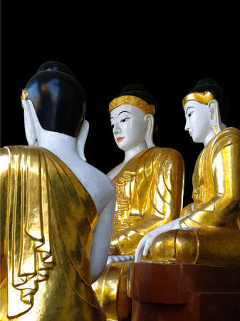Gold and white Buddha statues at the Shwedagon Pagoda in Yangon, Myanmar (Black background)の写真素材