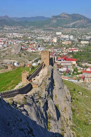 One of the walls and towers of Genoese fortress on a rocky ledgeの写真素材