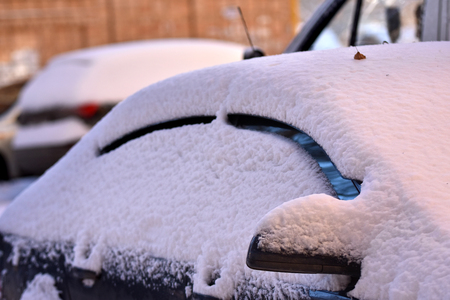 Winter cars in the yards are covered with a thick snow coatの写真素材