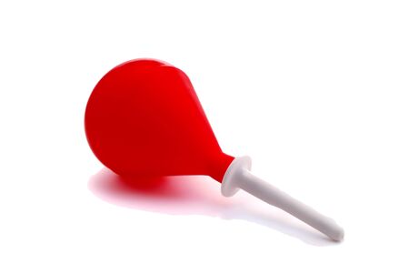 Red rubber enema on a white backgroundの写真素材