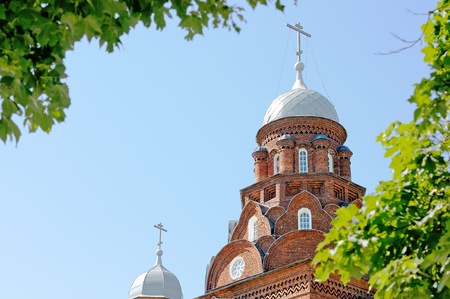 The Orthodox cathedral. The church of red brick. Cathedral in the background of blue sky.