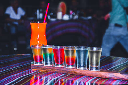The bartender prepares cocktails. Multi-colored cocktail. Refreshing cocktails. rainbow cocktails....