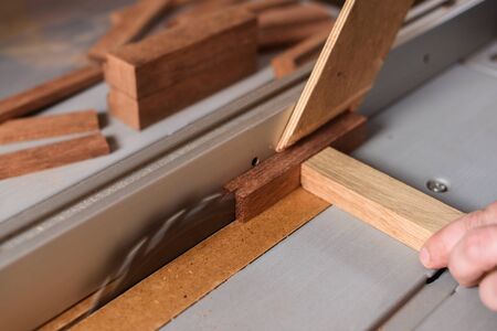 Circular saw sawing wood brick closeup