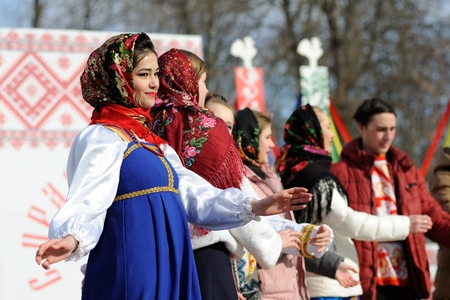 Orel, Russia - February 26, 2017: Maslenitsa fest. Girls in Russan sarafans and shawls singing closeupのeditorial素材