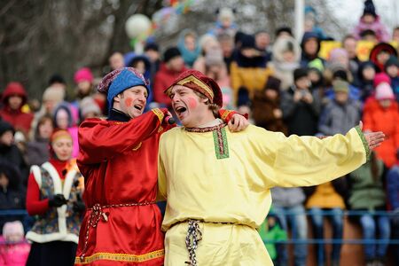 Orel, Russia - February 26, 2017: Maslenitsa fest. Buffoons Skomorokhs singing closeupのeditorial素材