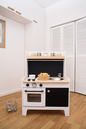 Designer toy kitchen. Black and white kitchen for children decorated with homemade cookies verticalの写真素材